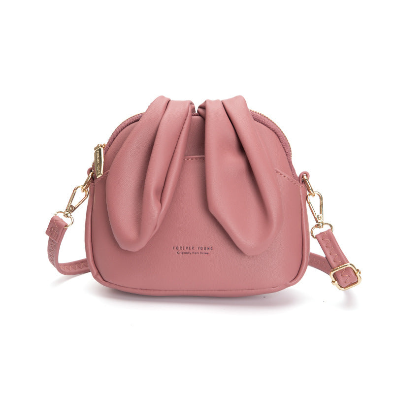 sac bandoulière au design original avec oreilles de lapin, mignon et tendance, parfait pour un style ludique et moderne.